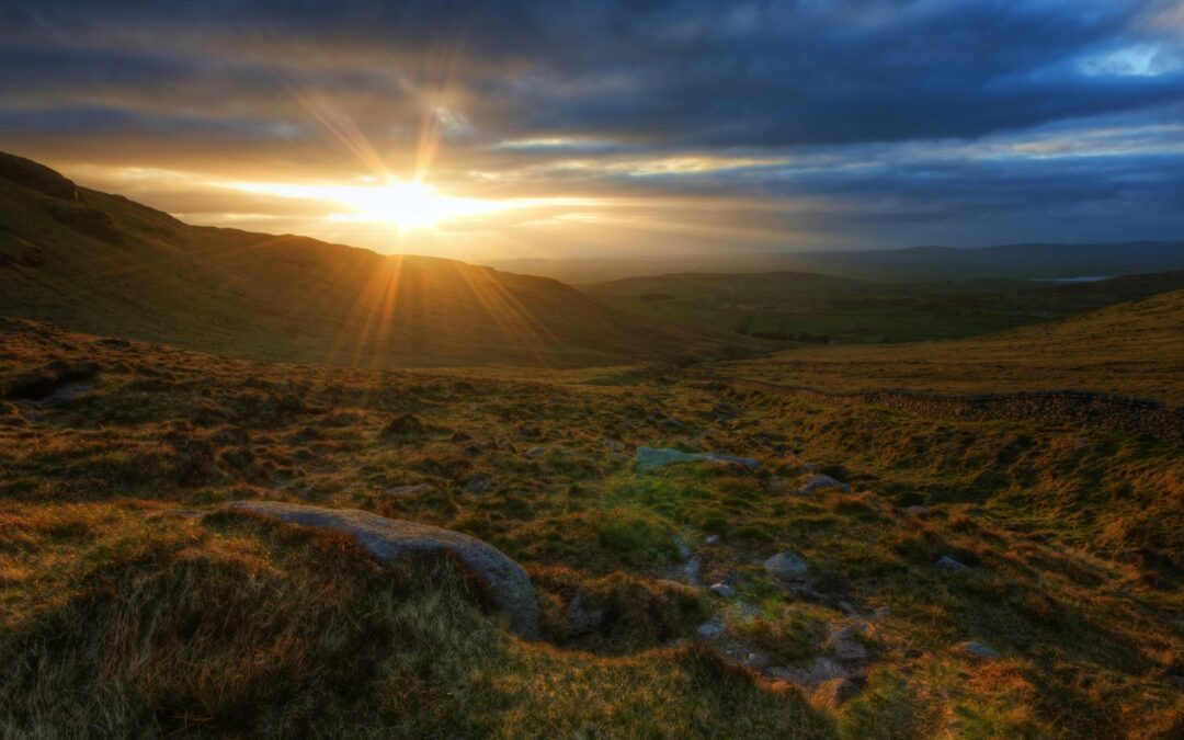 Sunset over a grassy landscape in Gloucester County, symbolizing hope and new beginnings in personal injury legal support.